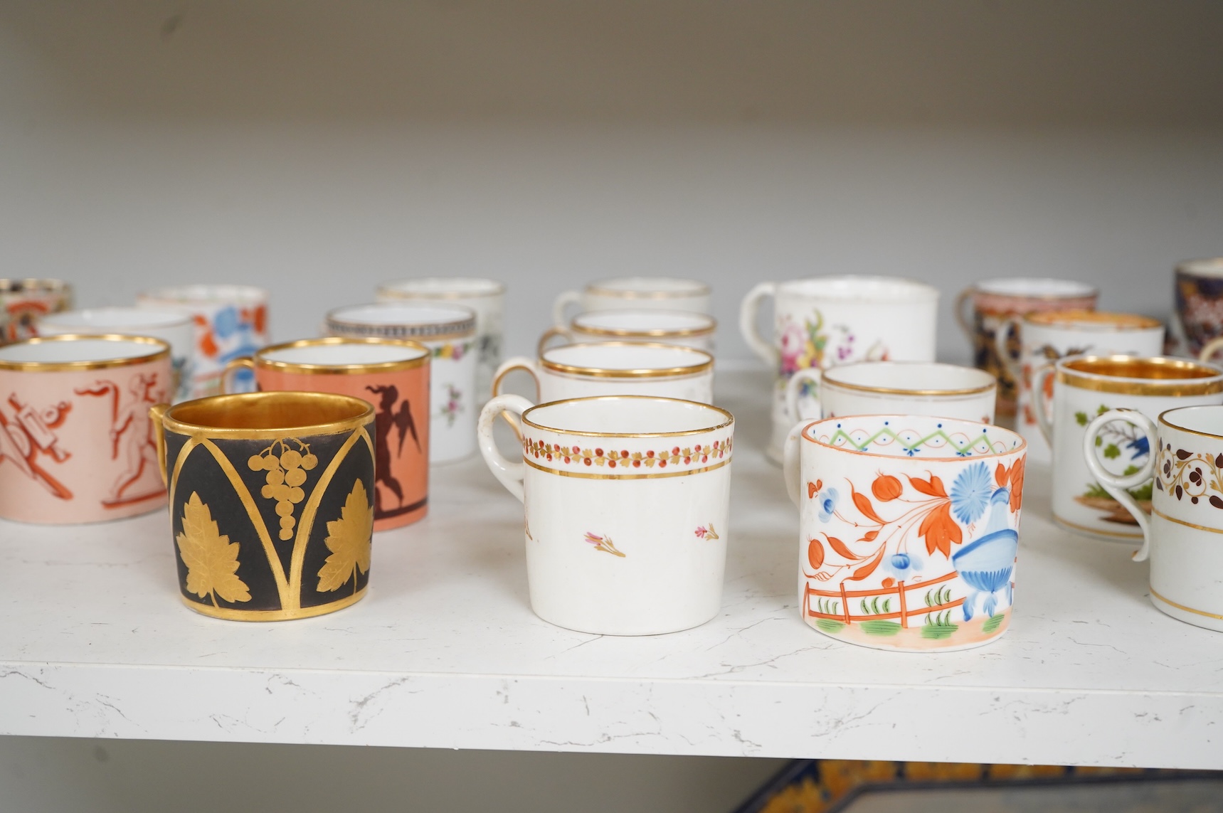 A collection of late 18th/19th century English and French porcelain coffee cans, tea cups and vases, some in Imari pattern